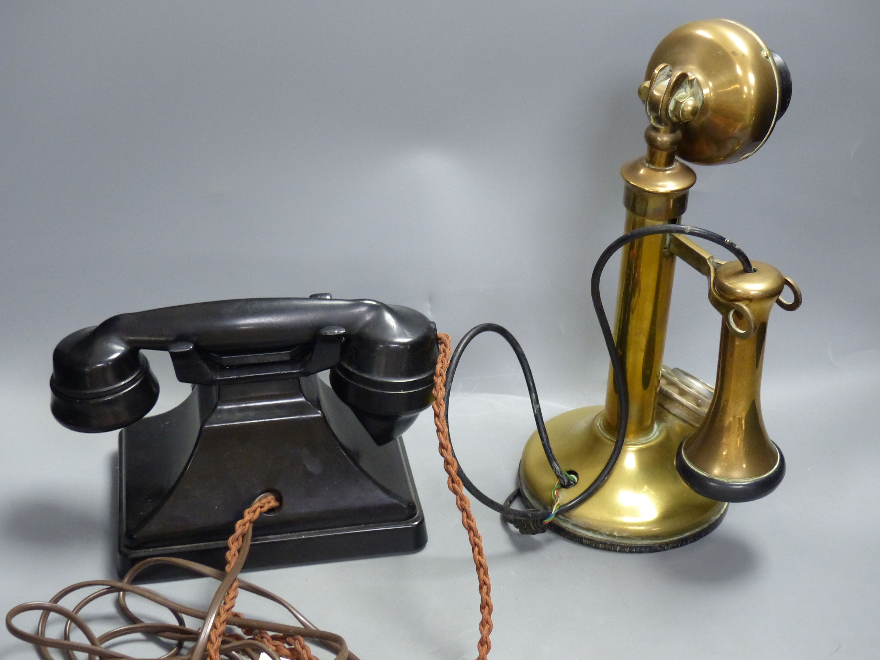 A vintage stick telephone and a black Bakelite telephone